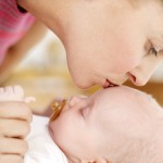 Woman Kissing the Top of a Baby's Head (3-6 Months)